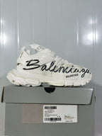 White Balenciaga Track sneaker with black graffiti-style lettering, shown on its box; the box label displays size E 40.