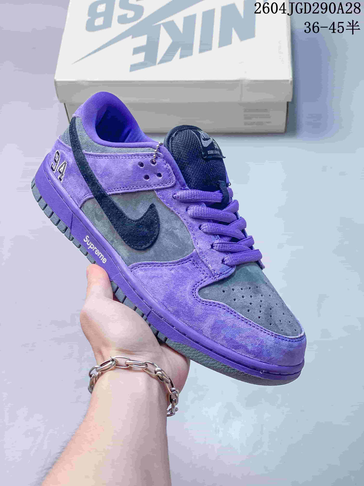 Purple and gray Nike Dunk Low sneaker with dark Swoosh detail; image overlay shows sizes 36–45.5.