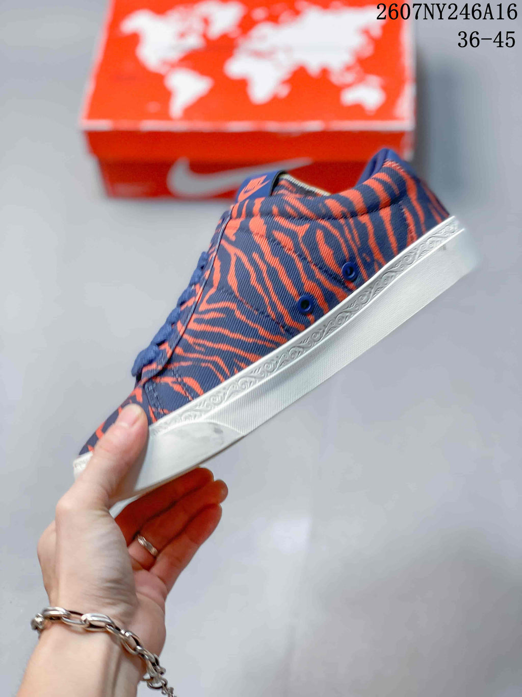 Side profile highlighting the blue and orange patterned upper and white rubber sole.