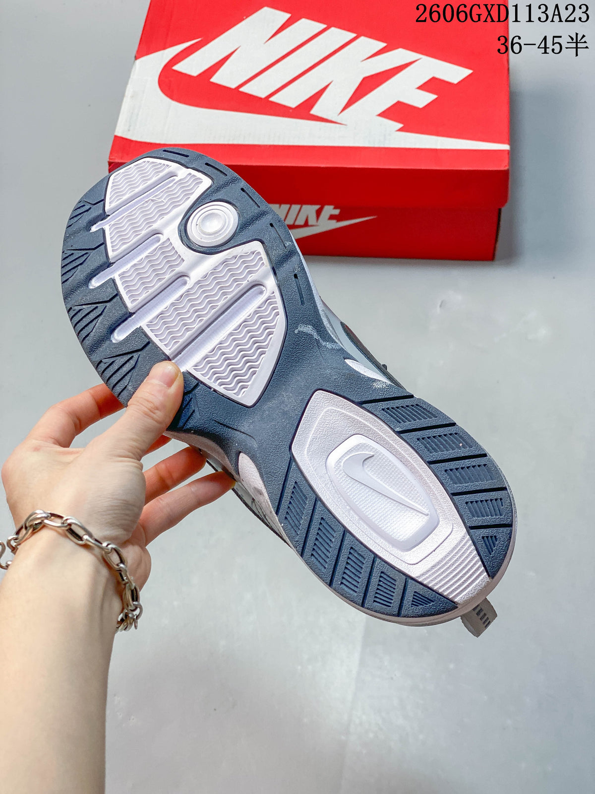 Close-up of the sneaker outsole showing its patterned tread and contrasting sections.