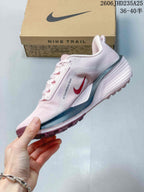 Side profile showing pale pink upper and contrasting details