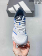 Front view showing white laces, mesh-style tongue, blue details and adidas tongue branding.