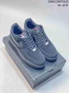 Pair of black Nike Air Force 1 low-top sneakers displayed on a shoe box, with style code JD975A25 and size range text visible above.