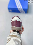 Rear view showing the burgundy heel, white stripe detail, and gum-colored outsole.