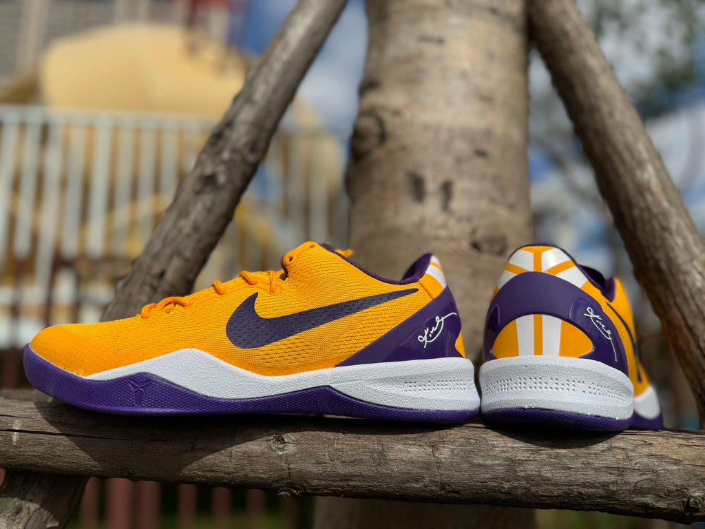 Rear view showing the gold, purple, and white heel details