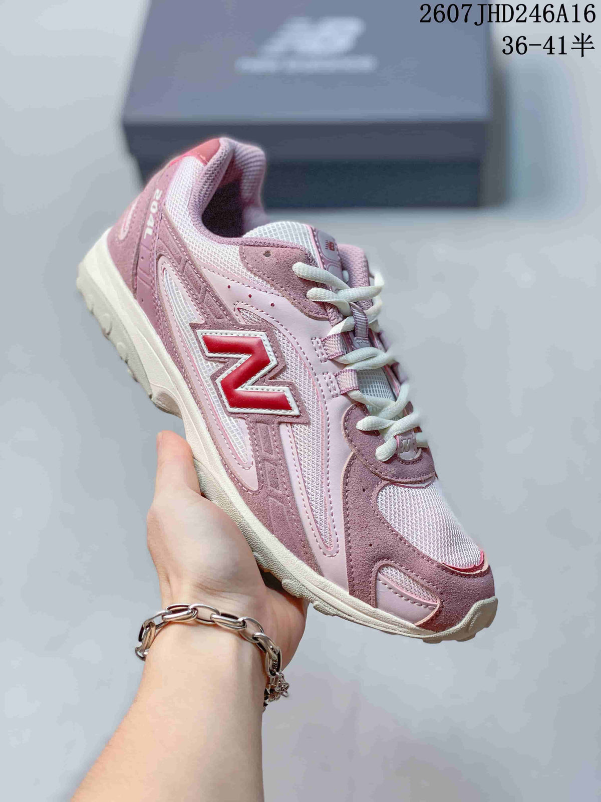 Angled side view showing the pink and white upper, large side logo, white laces, and low-profile sole.