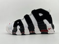 Side view of a black and white Nike Air More Uptempo 96 sneaker with red accents