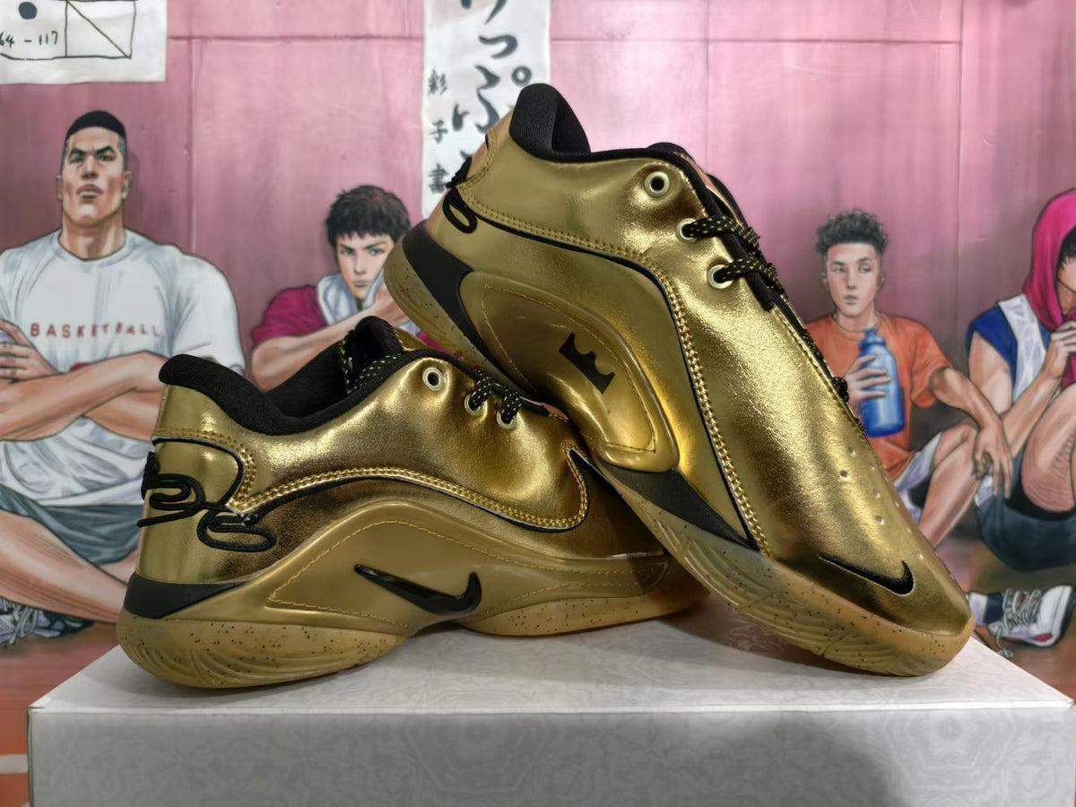 Pair of gold-tone Nike basketball sneakers shown from the side, with black details and translucent gum-colored soles.