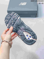 Outsole view of a New Balance sneaker showing the patterned dark rubber tread and central cutout area.