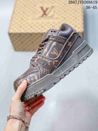 Side view of the brown low-top sneaker showing monogram-patterned panels, logo hardware, layered midsole, and lugged outsole.