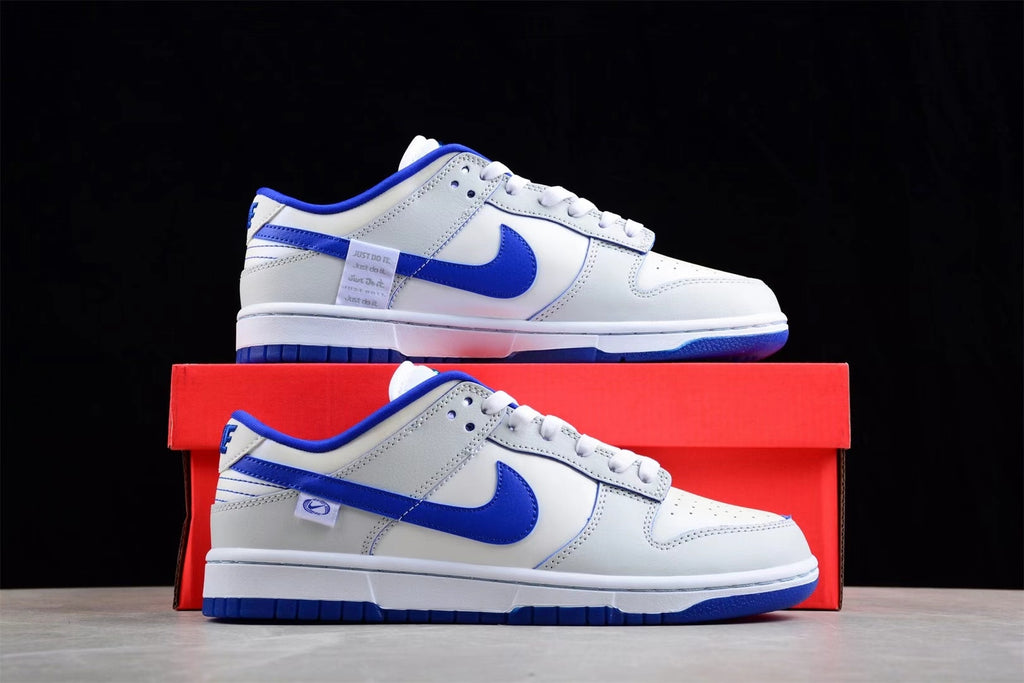 Pair of white and blue Nike SB low-top sneakers displayed with a red shoe box.