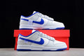 Pair of white and blue Nike SB low-top sneakers displayed with a red shoe box.