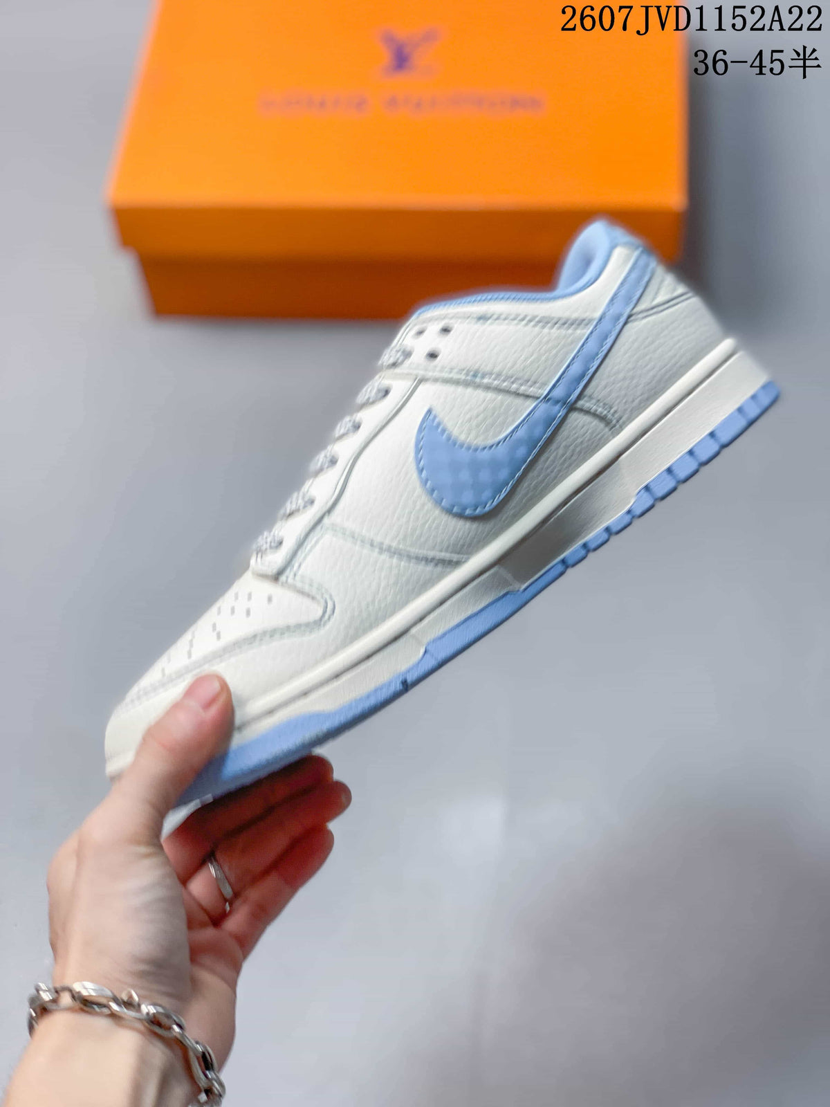 Side profile showing the light blue Swoosh, white upper and light blue outsole edge.