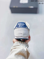 Rear view of a white sneaker showing the padded heel and blue Onitsuka Tiger tongue branding; overlay shows model code 2607JDY493A23 and size range 36–45.
