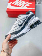Side view of the white and dark gray Nike Shox Ride 2 sneaker