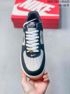 Top view showing the white perforated toe box, navy overlays, white laces, and tongue branding.