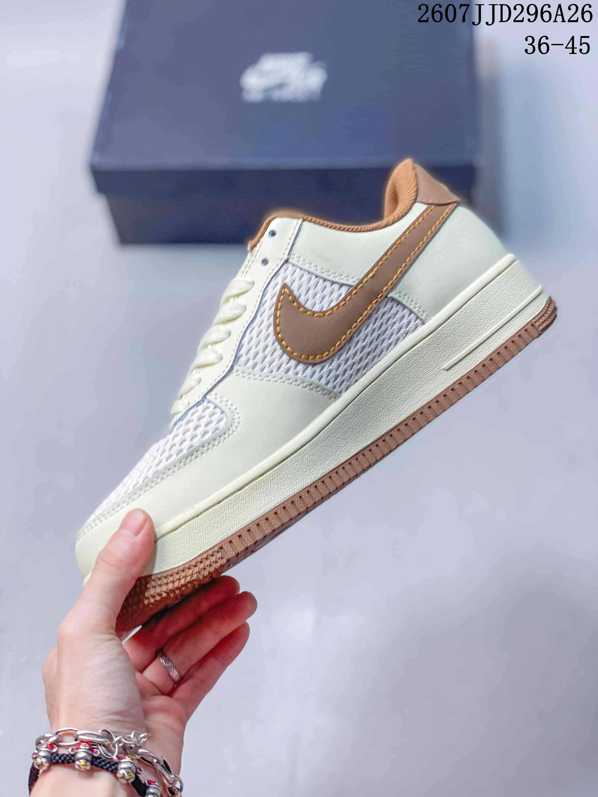 Side view showing the cream upper, white mesh panels, brown Swoosh, and gum-colored outsole.