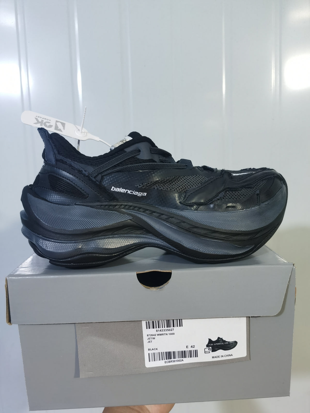 Black Balenciaga sneaker displayed on its box; the label shows style code 872624 W2RTN 1000, color Black, and sample size EU 42.