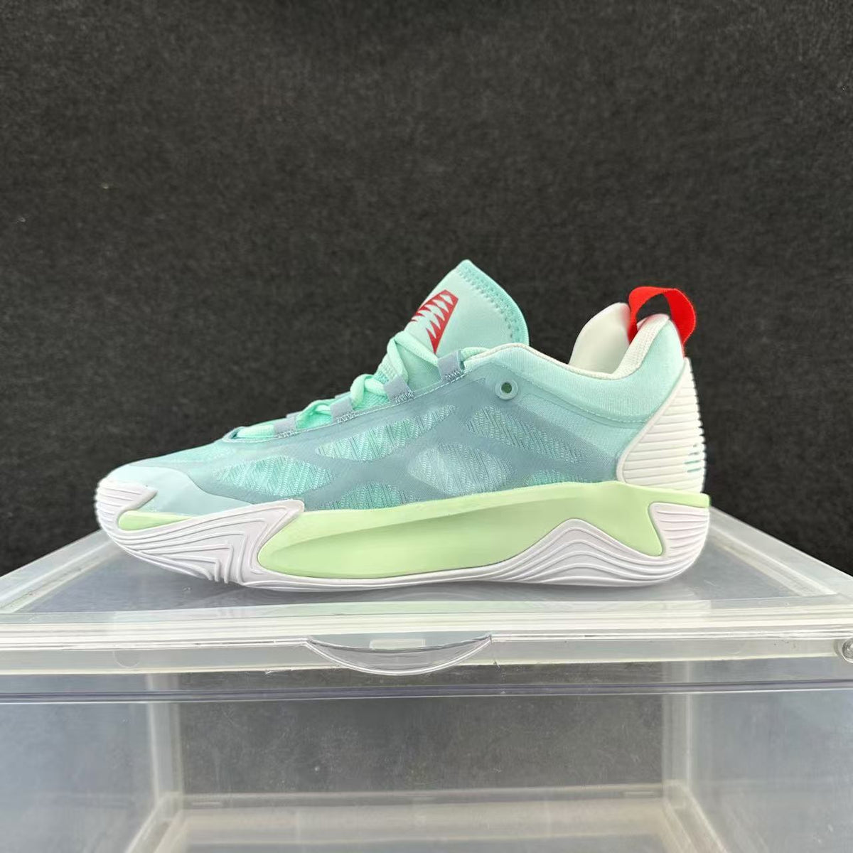 Mint green and pale aqua low-top basketball shoe with a white sole