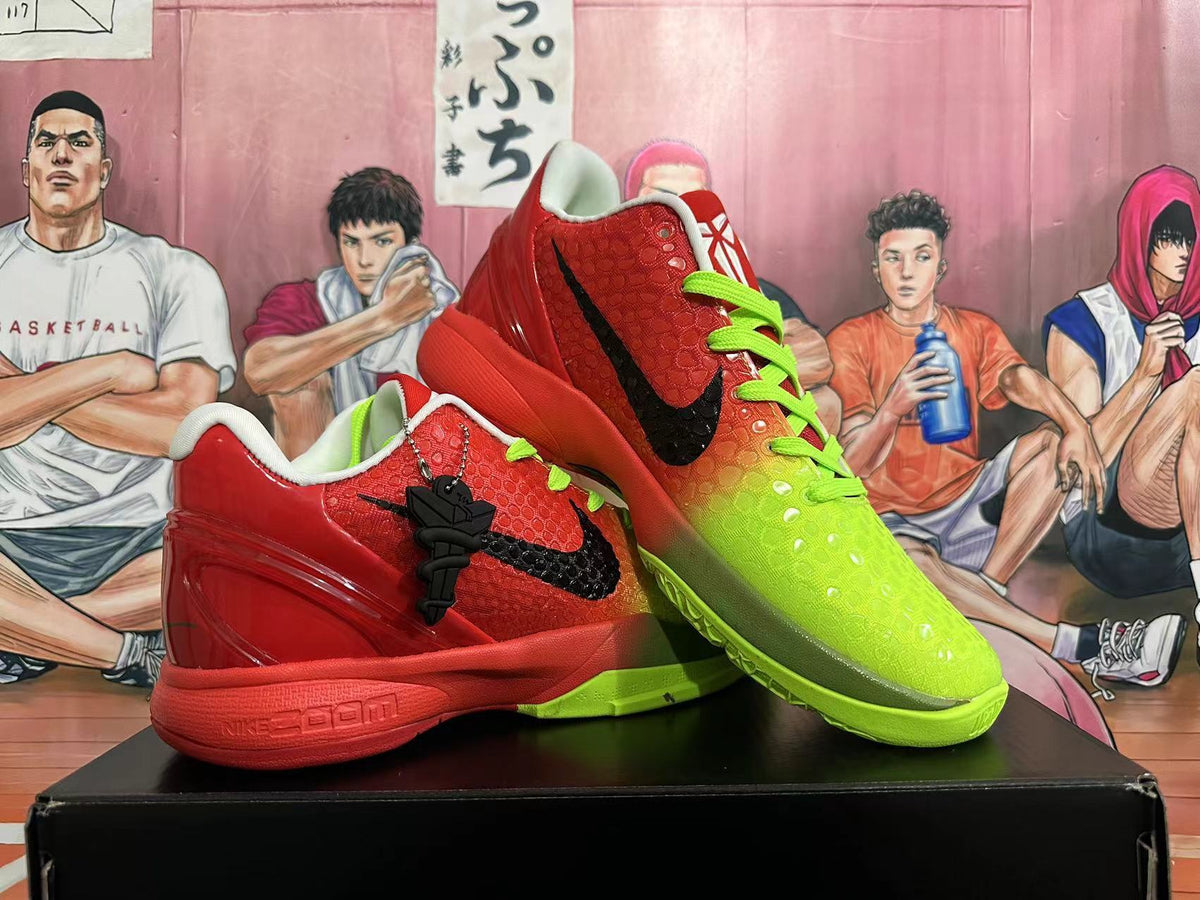 Two red and volt green Nike Kobe basketball shoes displayed at an angle, showing the side logos and textured uppers.