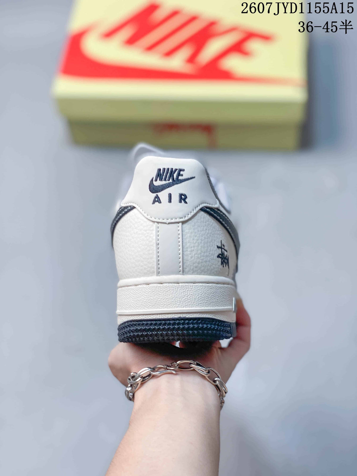 Rear view of a Nike Air Force 1 sneaker showing the white heel, AIR branding, rear graphic detail and dark outsole.