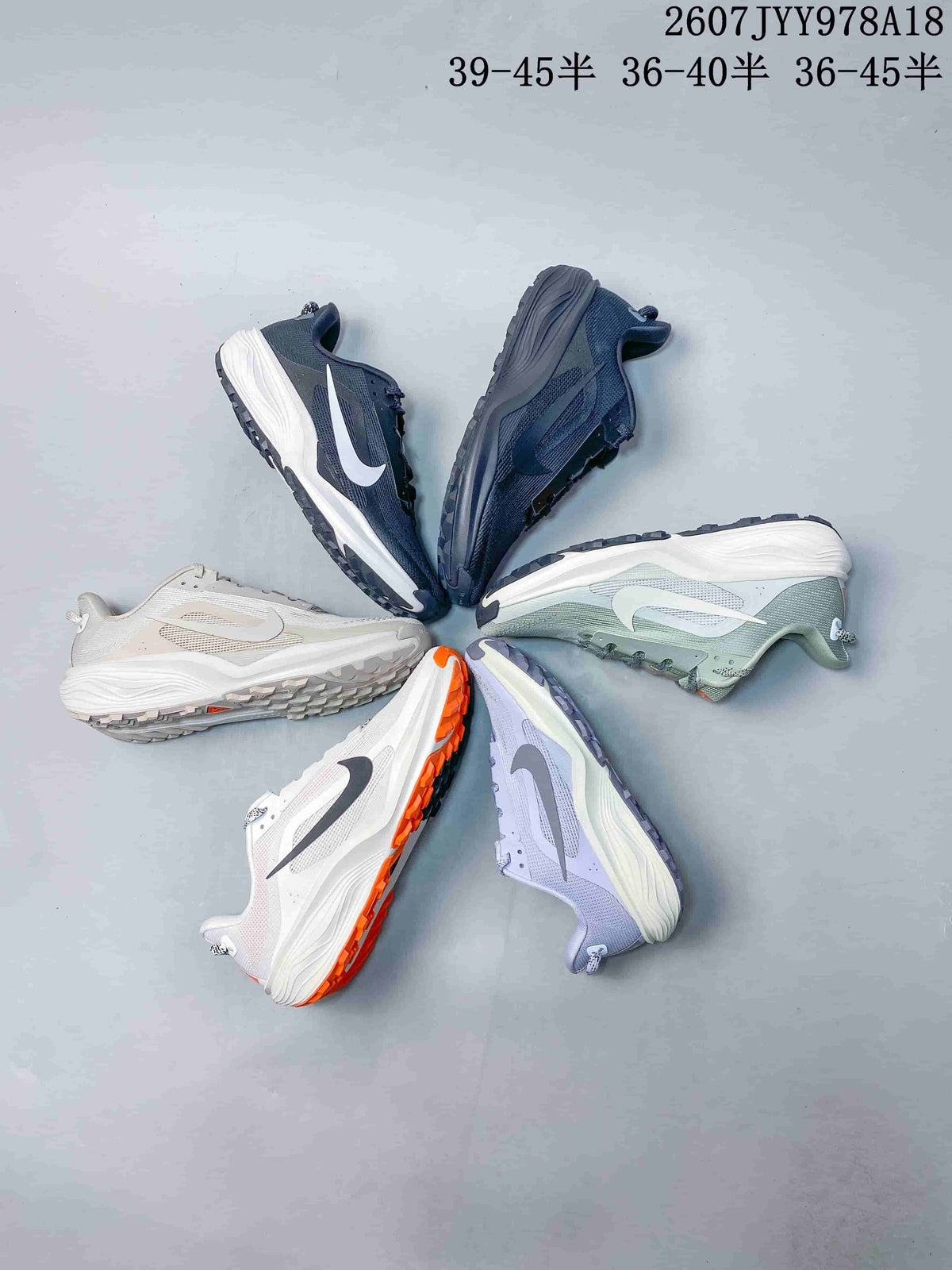 Multiple Nike ACG Pegasus Trail colorways arranged together, including navy, green, white, orange-accented and lavender styles.