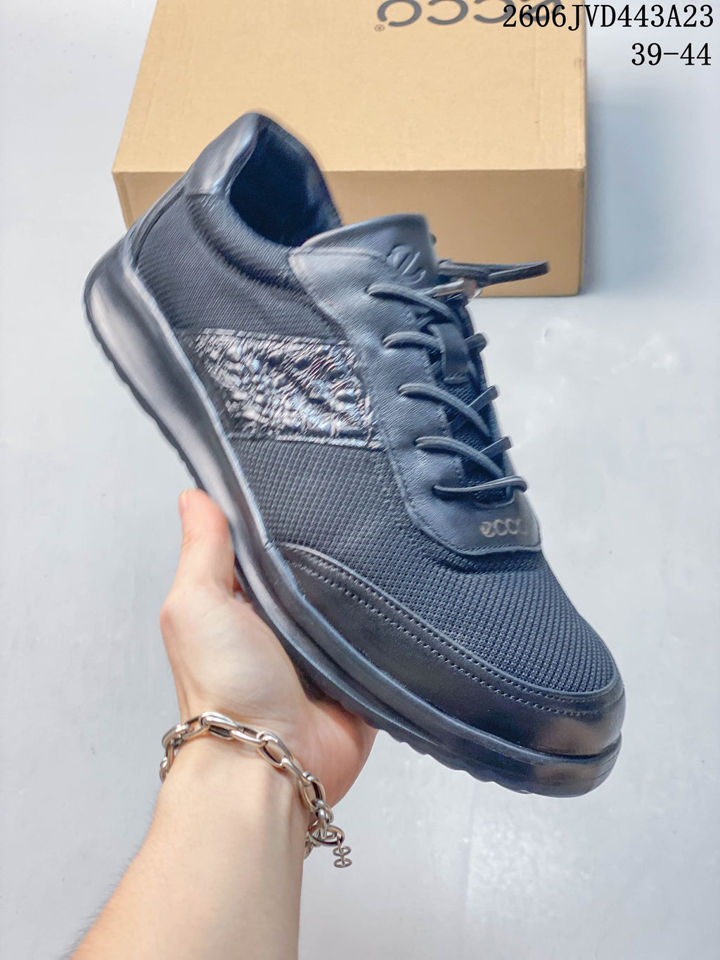 Angled view of the dark navy sneaker with mesh and textured side panels