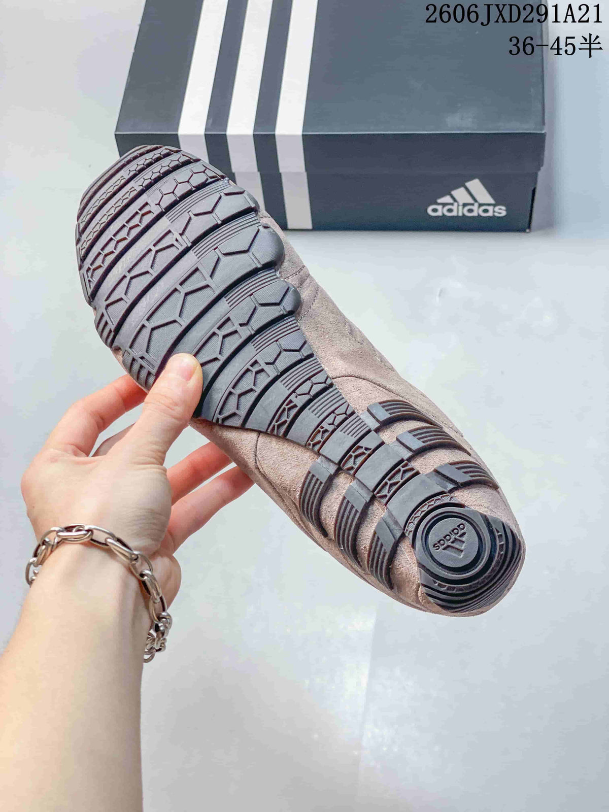 Close view of the sneaker outsole showing a segmented black rubber tread pattern.
