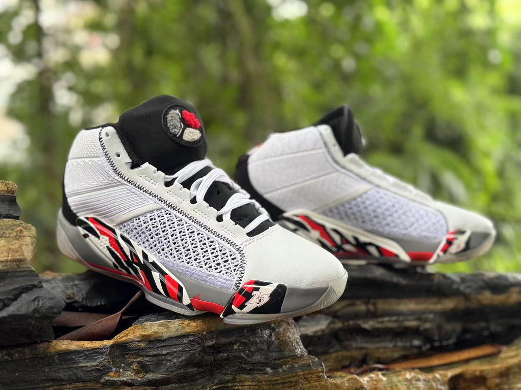 Angled front view of the pair, showing white laces and black tongues with red and gray details.