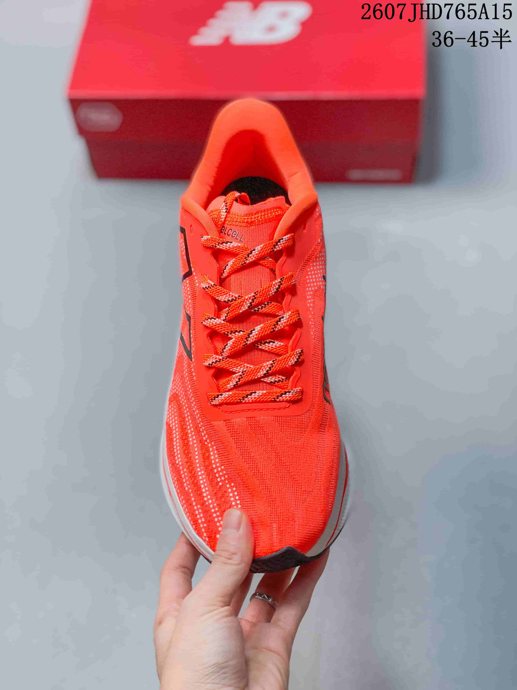 Top view of the orange running shoe with matching patterned laces and a structured tongue.