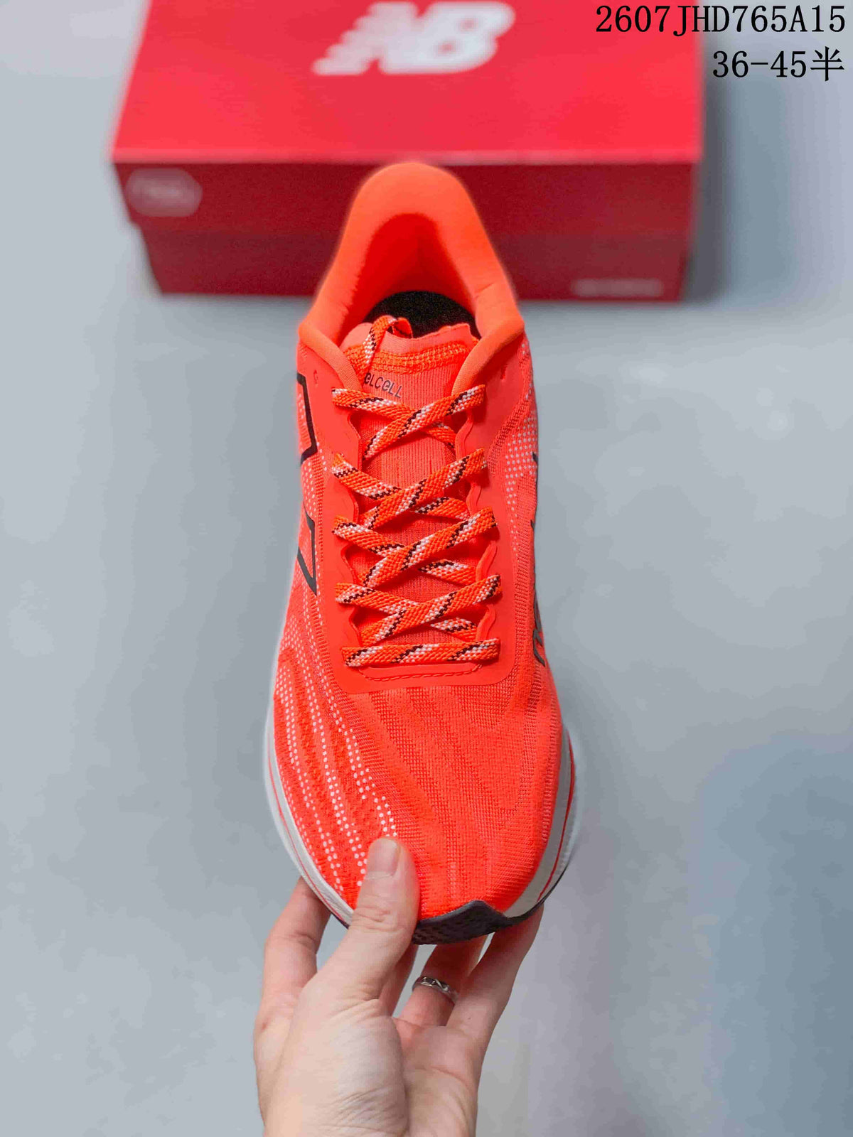 Top view of the orange running shoe with matching patterned laces and a structured tongue.