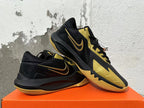 Pair of black and gold Nike basketball sneakers shown from the side