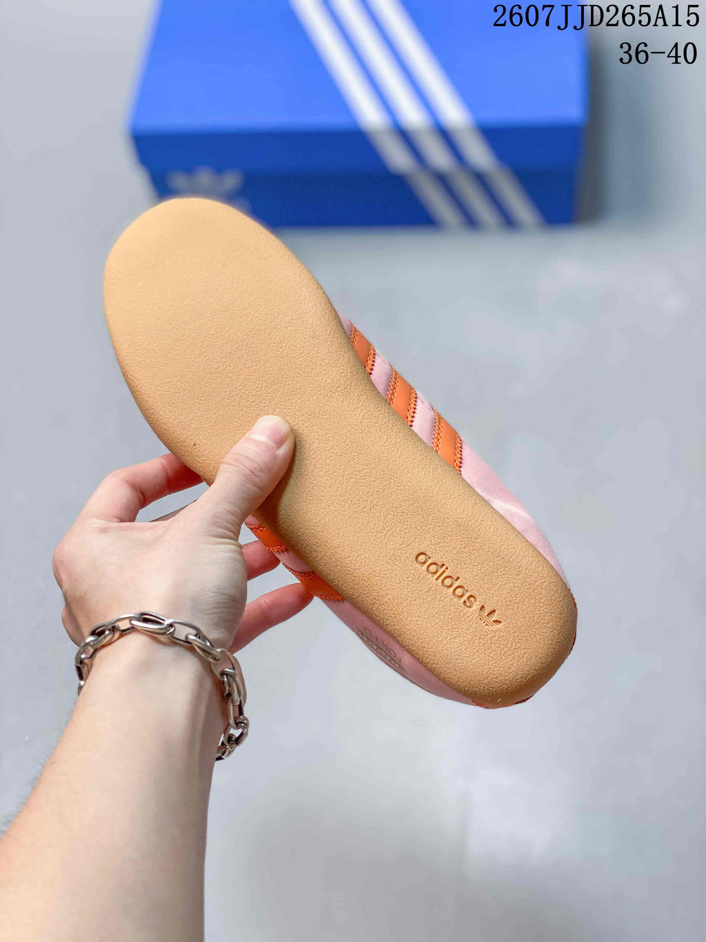 Close view of the textured gum-colored outsole with adidas branding.