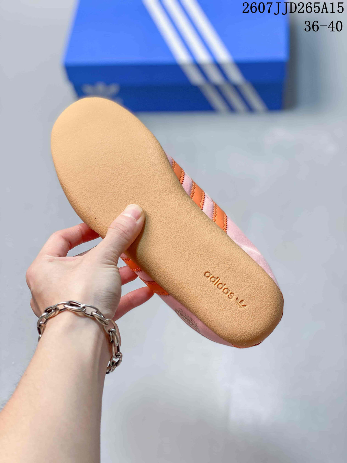 Close view of the textured gum-colored outsole with adidas branding.