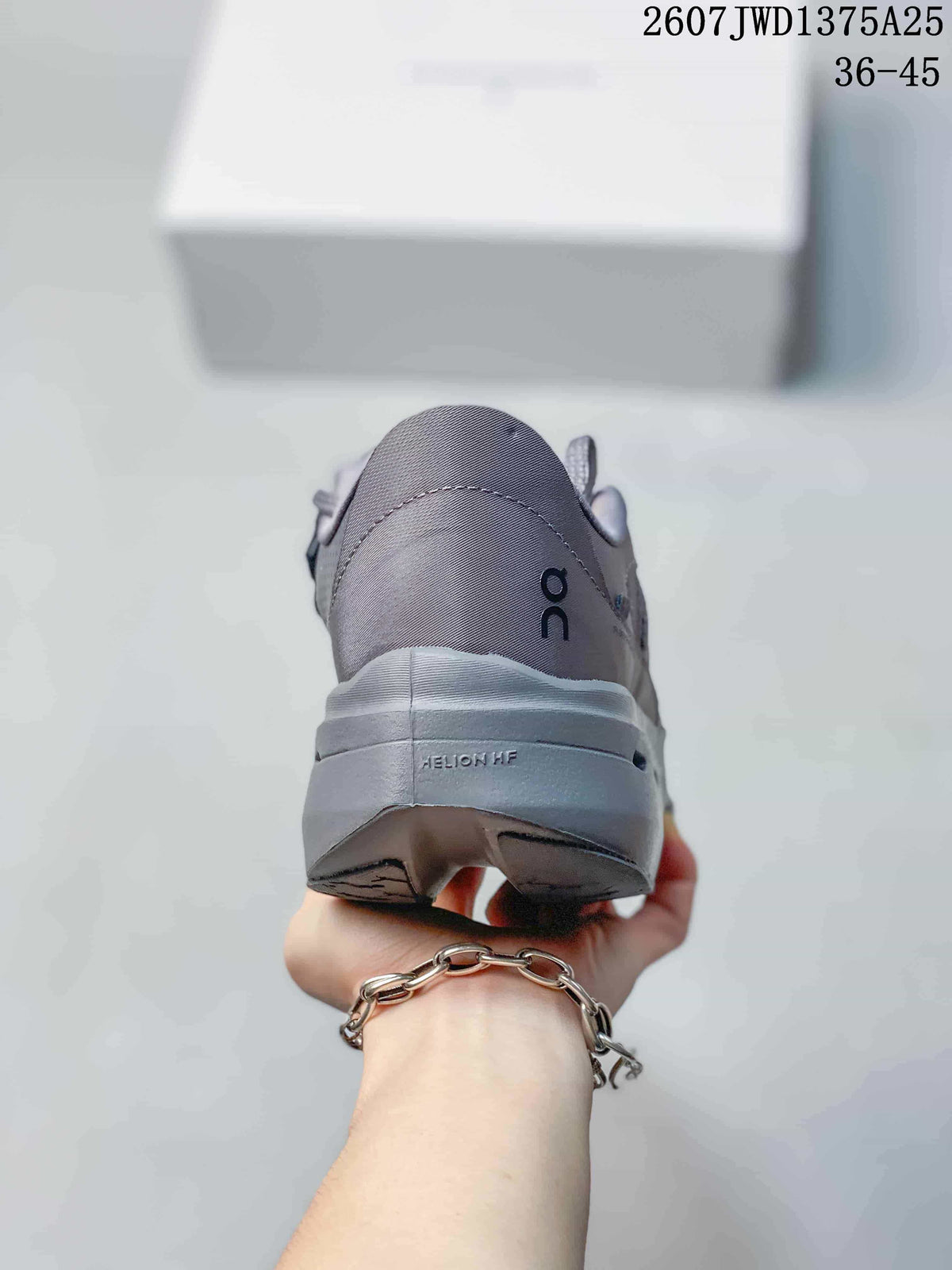 Rear view of the gray sneaker showing the padded heel, On logo, sculpted sole, and heel outsole details.