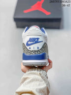 Rear view showing blue heel accents, elephant-print panels, and blue Nike Air branding.