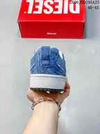 Rear view of a blue denim-look low-top sneaker with a white midsole.
