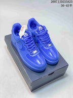 Pair of blue Nike Air Force 1 low-top sneakers displayed on a shoebox.