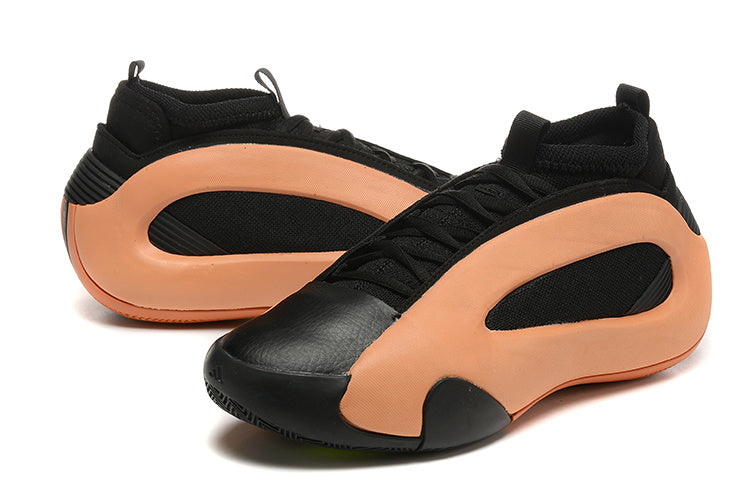 Pair of black and peach-orange Harden Vol. 8 basketball shoes