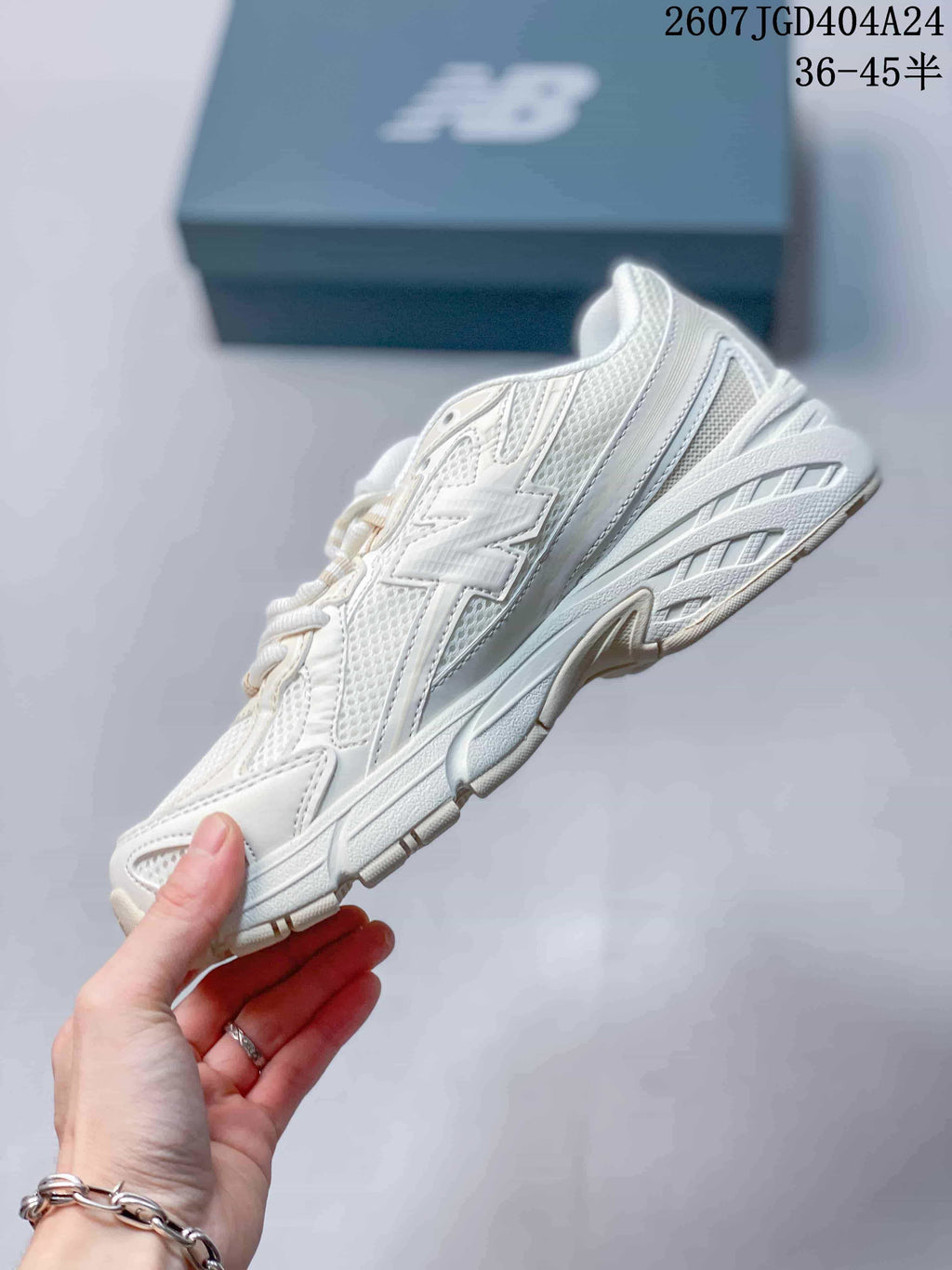 Side profile of the beige New Balance 740 sneaker showing mesh panels, overlays and the sculpted sole.
