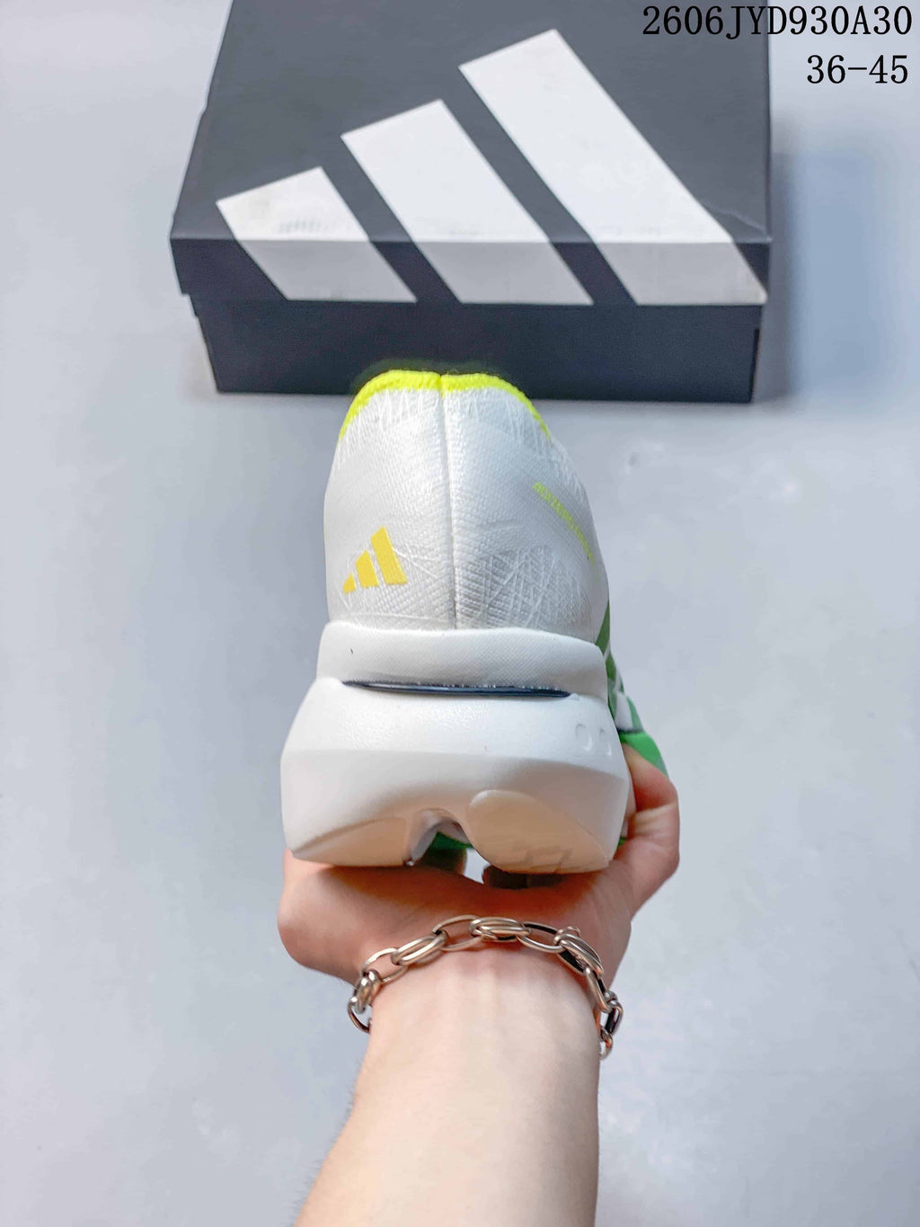 Rear view of the shoe showing the white heel, yellow trim, and sculpted sole.