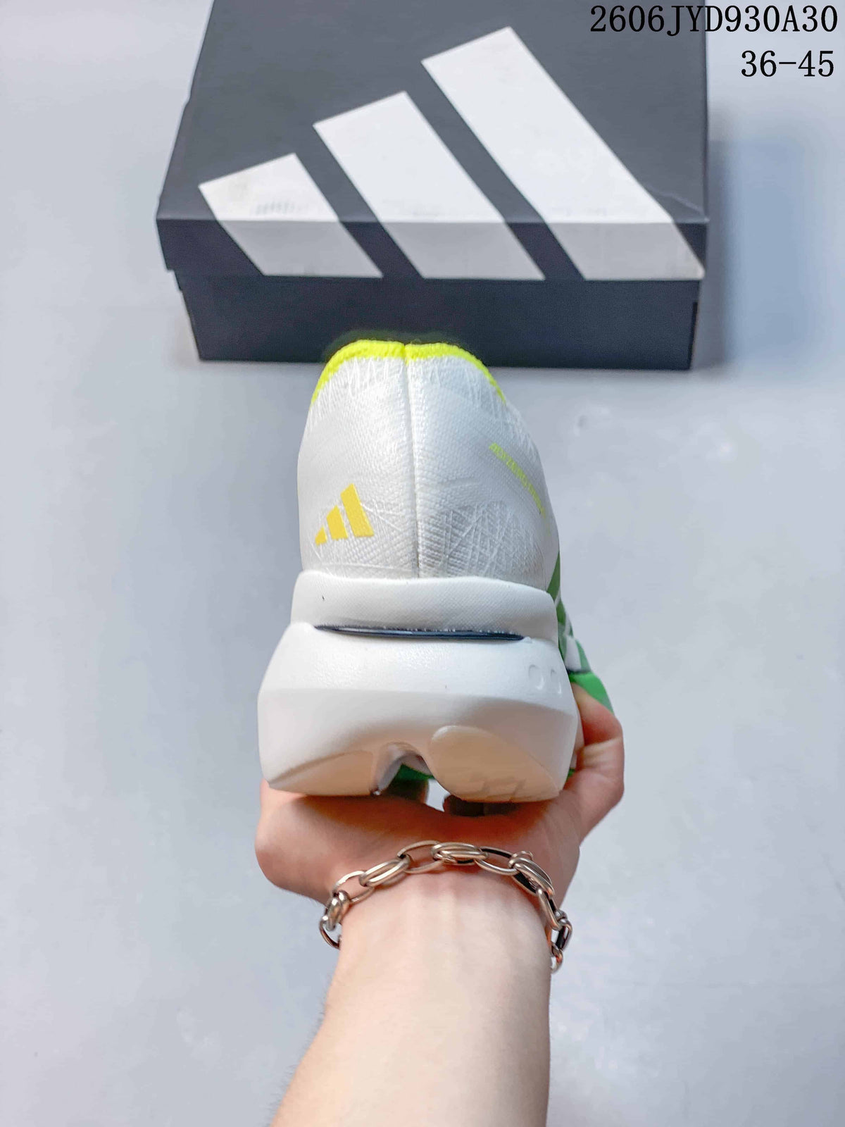 Rear view of the shoe showing the white heel, yellow trim, and sculpted sole.