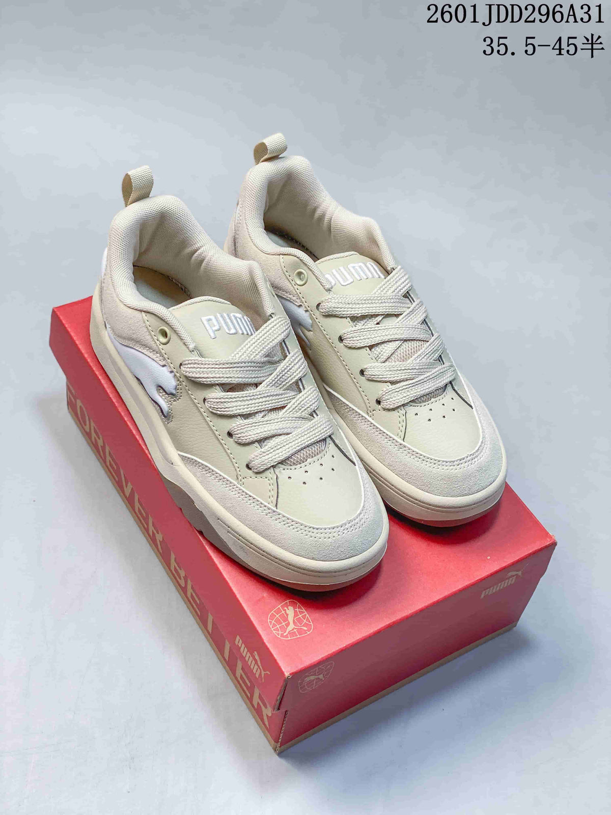 Pair of light neutral PUMA 180 sneakers with tonal accents and a chunky sole.