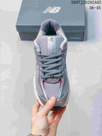 Top view of a gray New Balance 509 sneaker showing the lace-up design, mesh-like upper sections, and tongue branding.