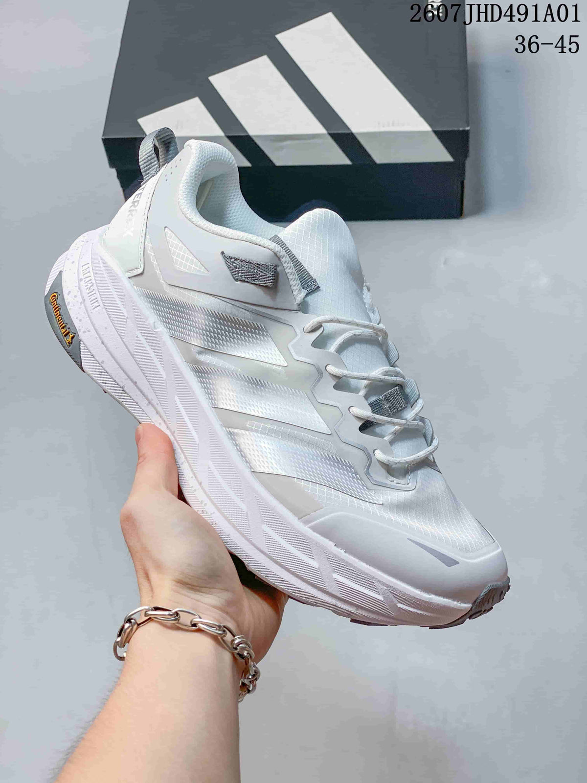 White Adidas Terrex low-top shoe with gray accents and a sculpted sole; image also displays the size range 36–45.