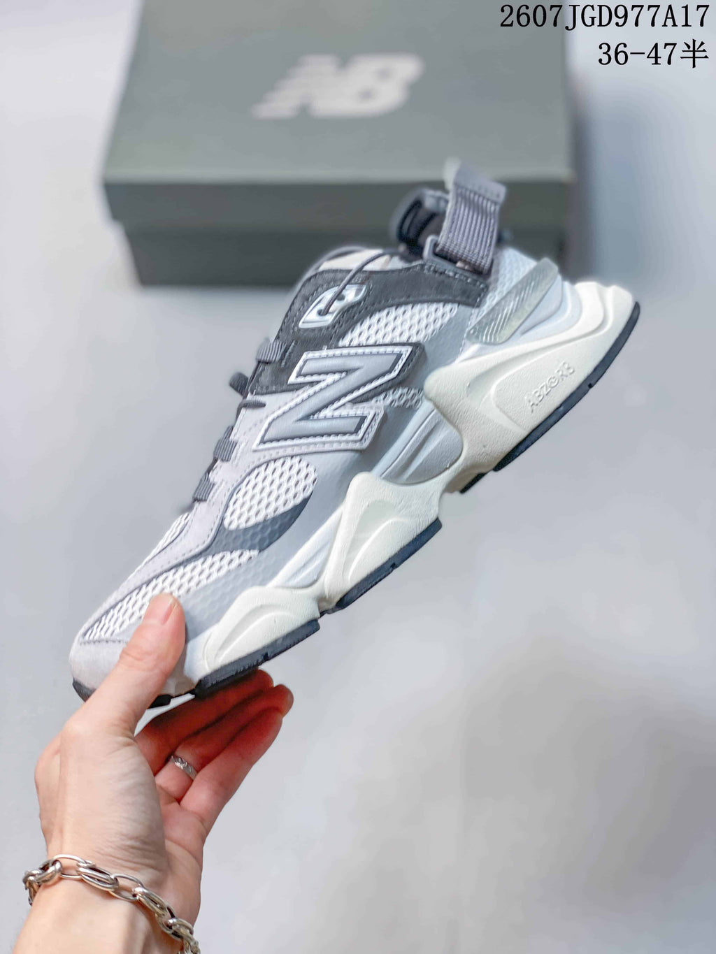 Side view highlighting the layered upper, mesh panels, chunky sole, and heel strap.