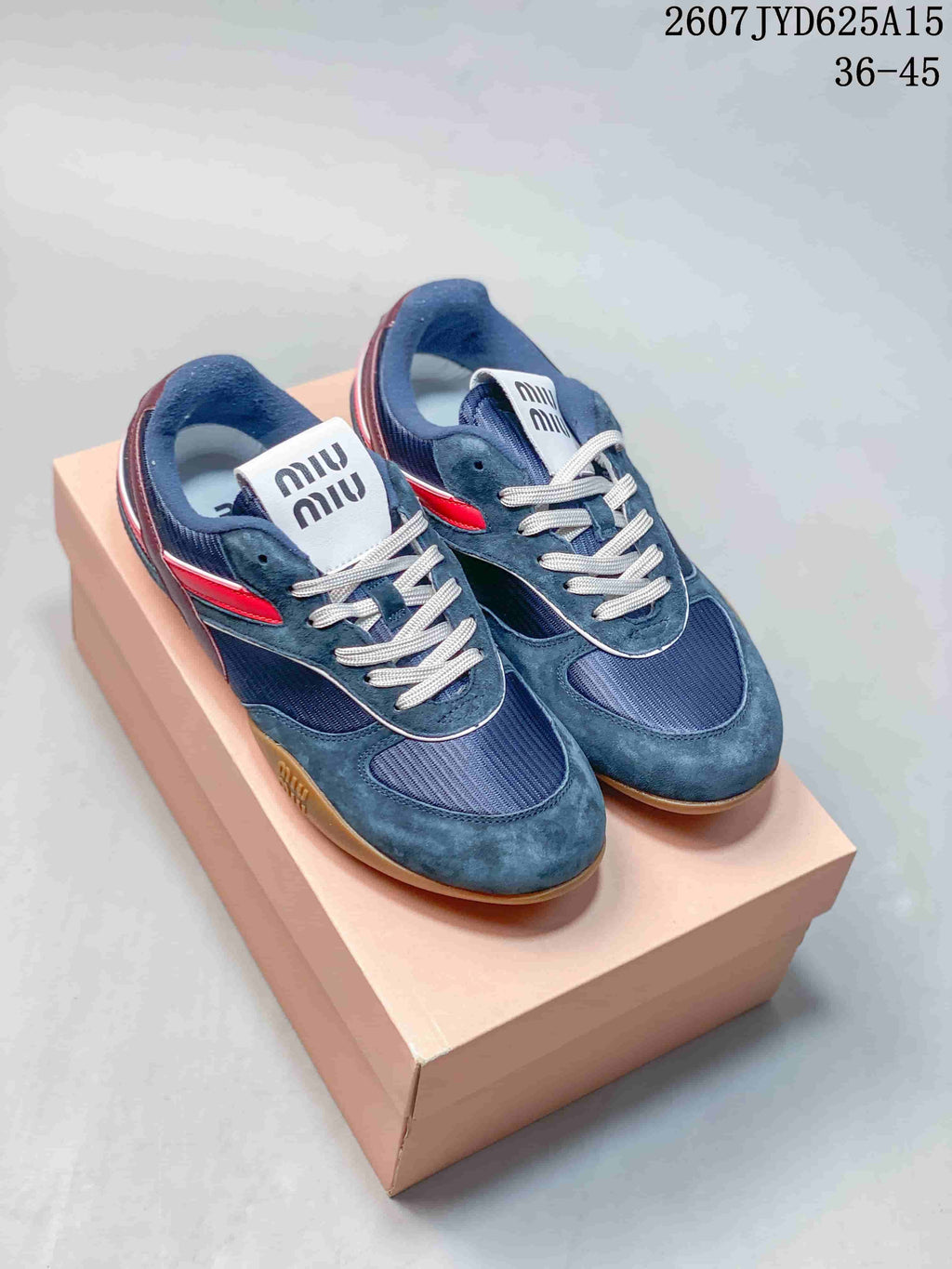 Pair of navy Miu Miu low-top sneakers with red and burgundy accents shown on a box; image text lists style code 2607JYD625A15 and sizes 36–45.