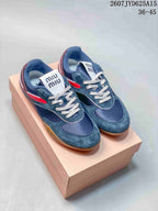Pair of navy Miu Miu low-top sneakers with red and burgundy accents shown on a box; image text lists style code 2607JYD625A15 and sizes 36–45.