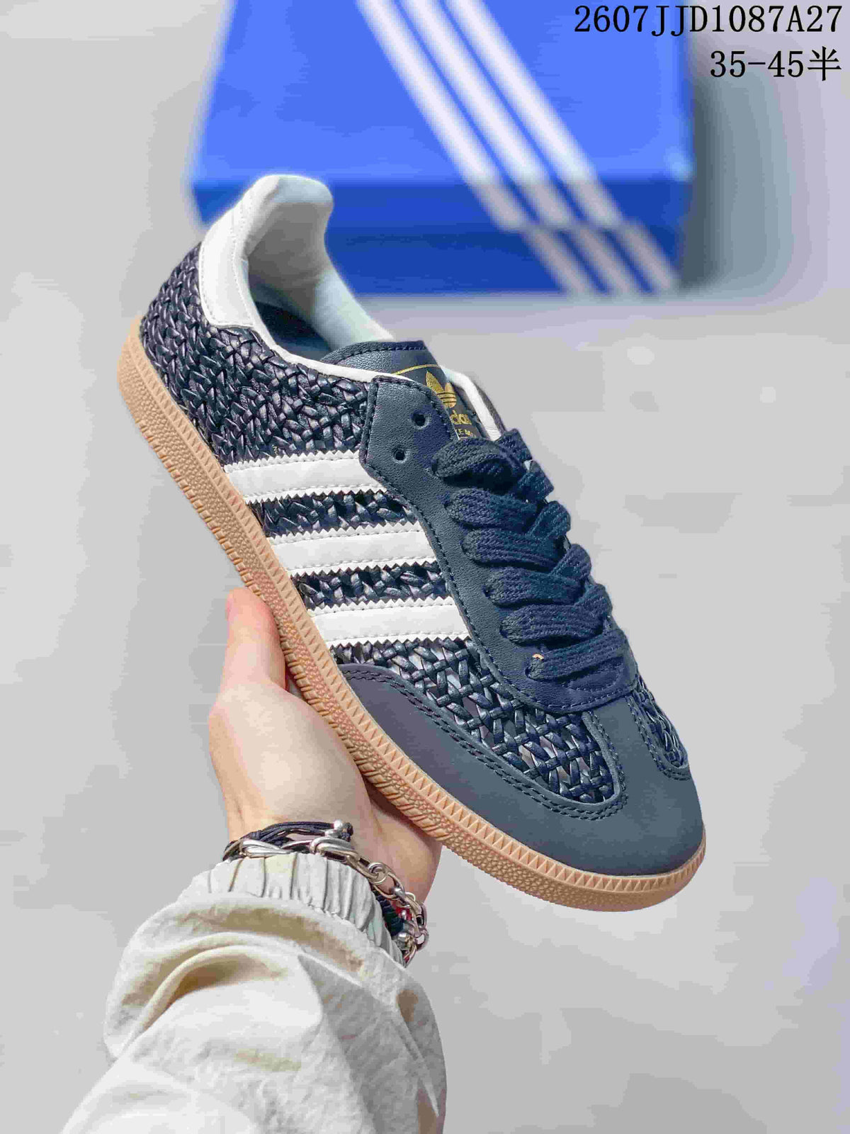 Angled side view of the dark navy and white low-top sneaker with three-stripe detailing and a gum-colored outsole.