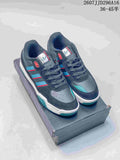 Pair of navy blue adidas Originals Tekkira Cup sneakers with teal and red accents displayed on a shoebox.